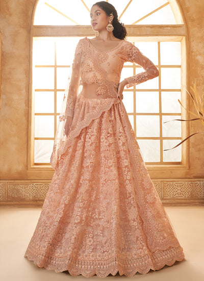 Peach Bridal Thread Embroidered With Stone Embellishment And Stone Work Net Lehenga Choli